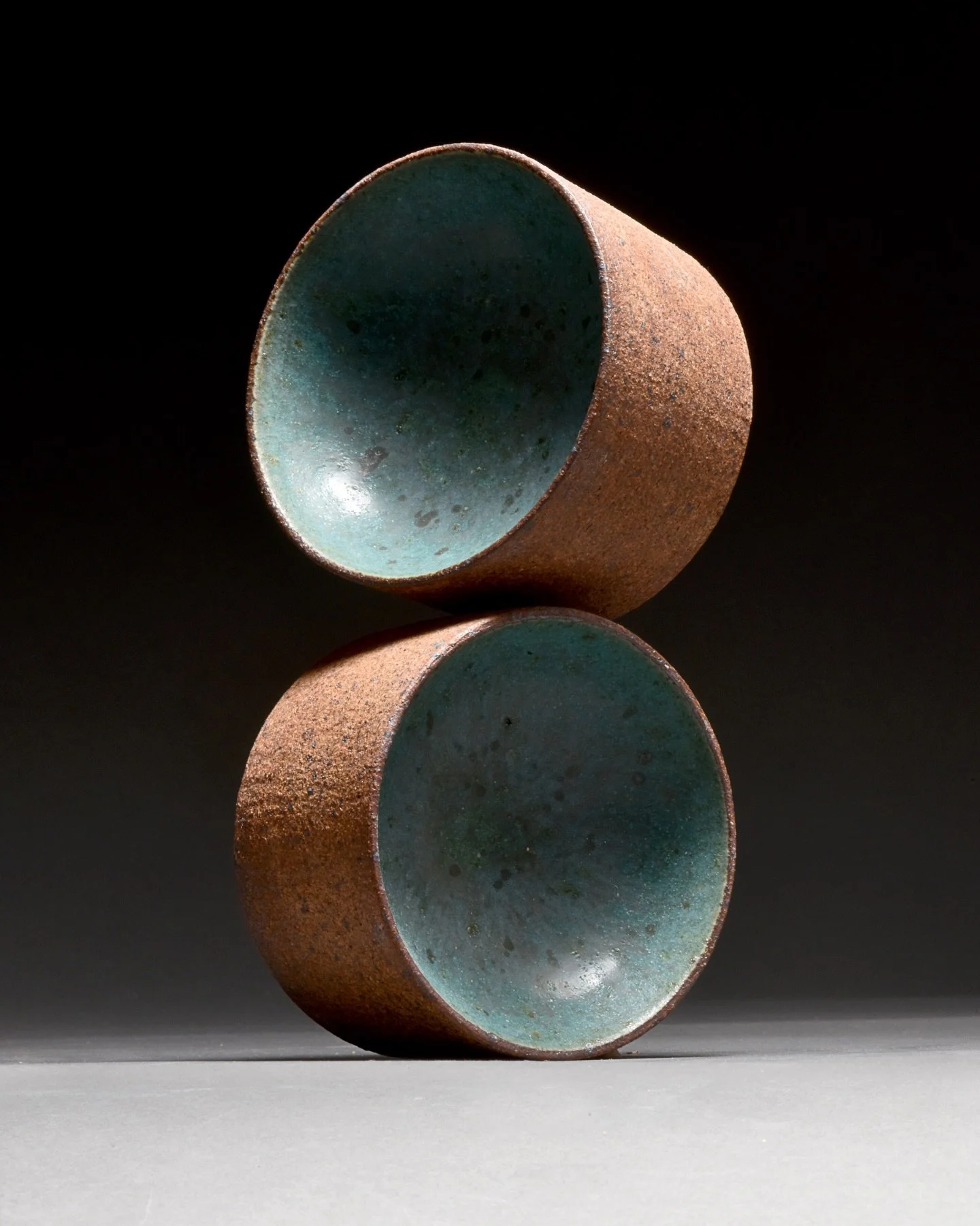 These little serving bowls are made upside down as a short cylinder. After a day or so of drying, the piece is turned up upside down, and the flat bottom is pushed in and formed to create the bowl shape.