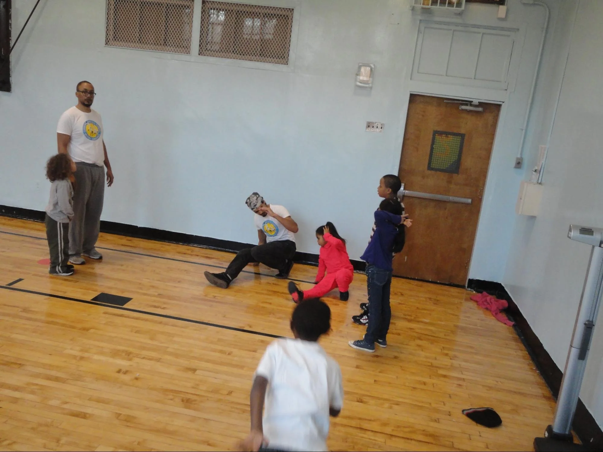 ABA teaching artist teaches role, a whole body roll important in capoeira floor movements.