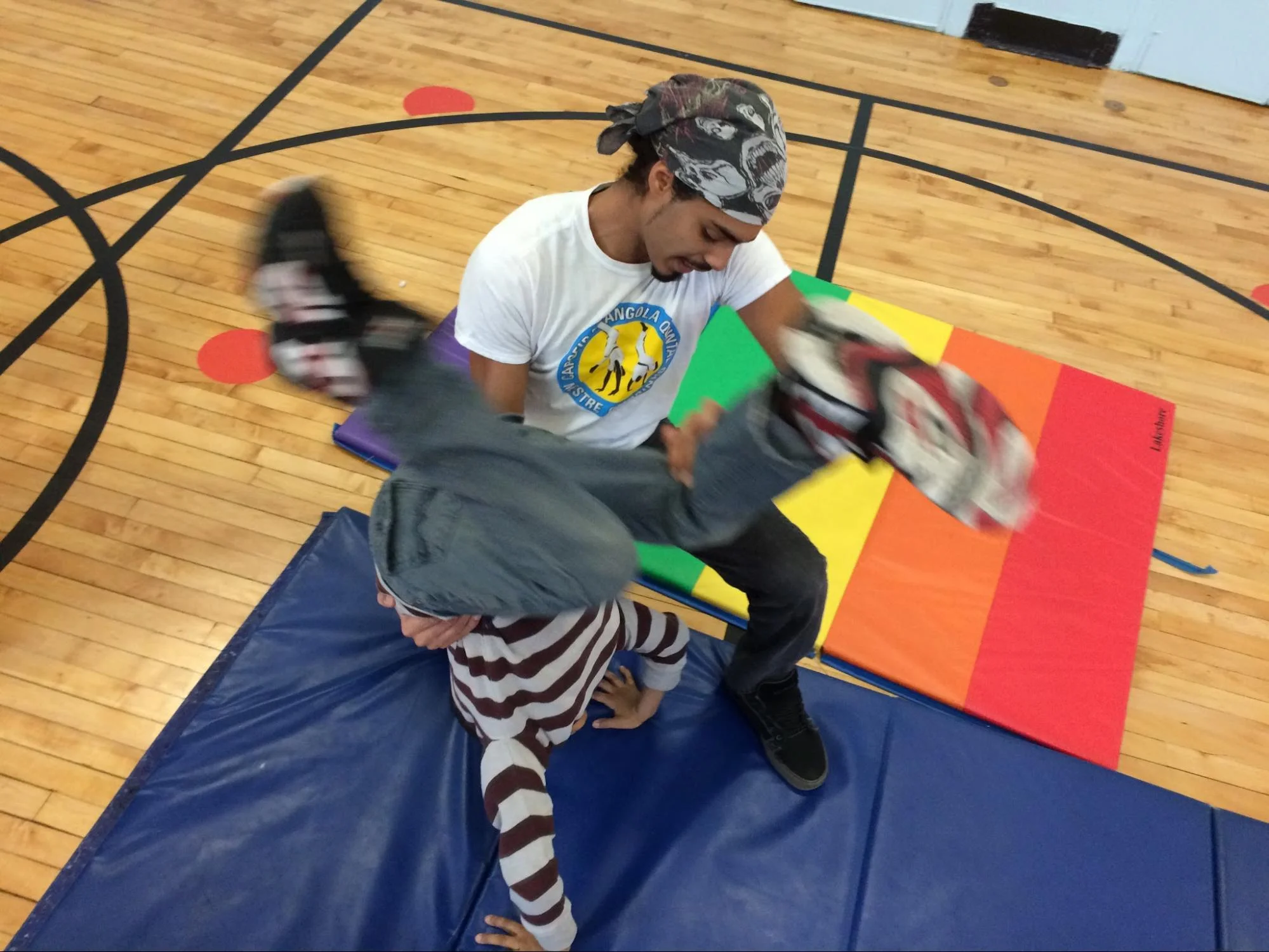 Safety first! Children learn to support their body with their arms and hands, then land on their feet.