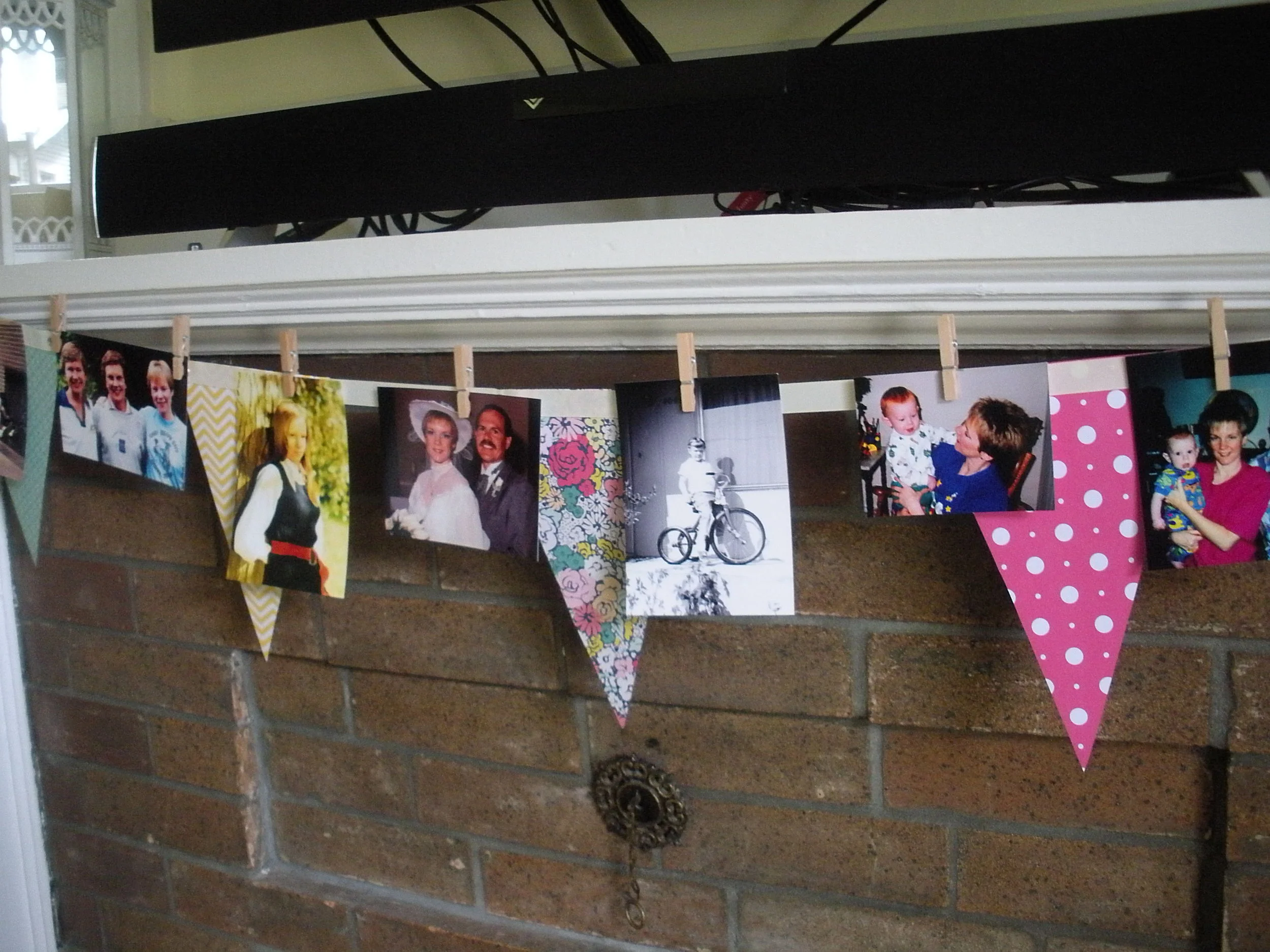 I used tiny clothespins to pin pictures of my Mom and family to the banner over the fireplace