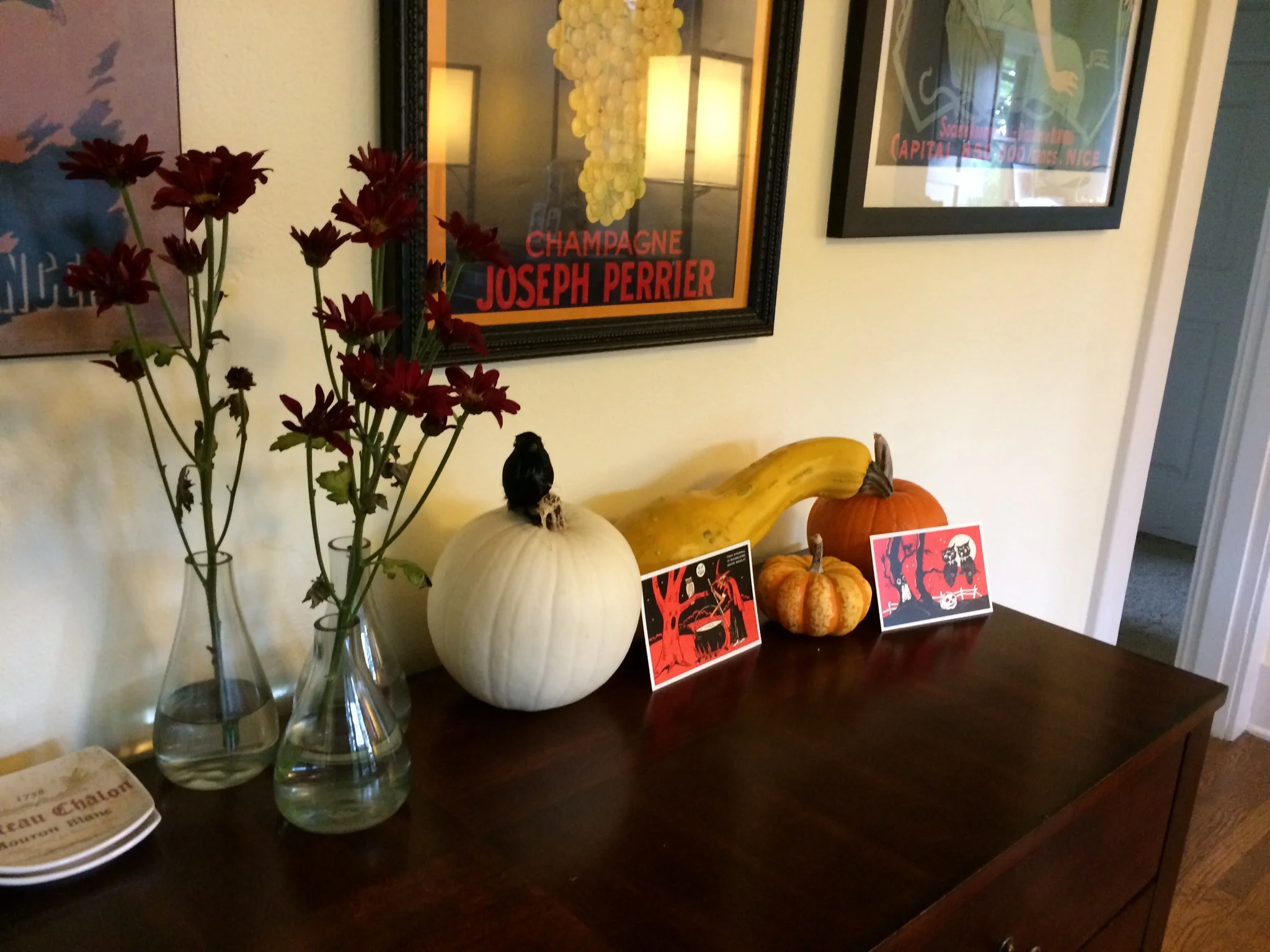 An assortment of squash and lovely purple mums add color to the bar. They also last a long time without much upkeep