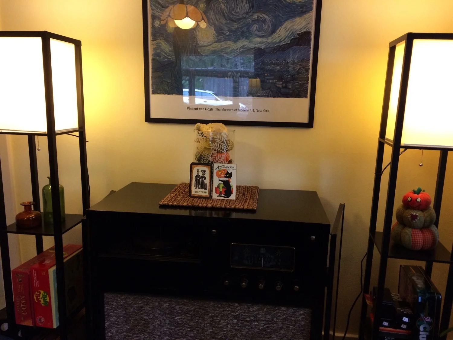 Fall vases and a wacky pumpkin man add charm next to the antique radio