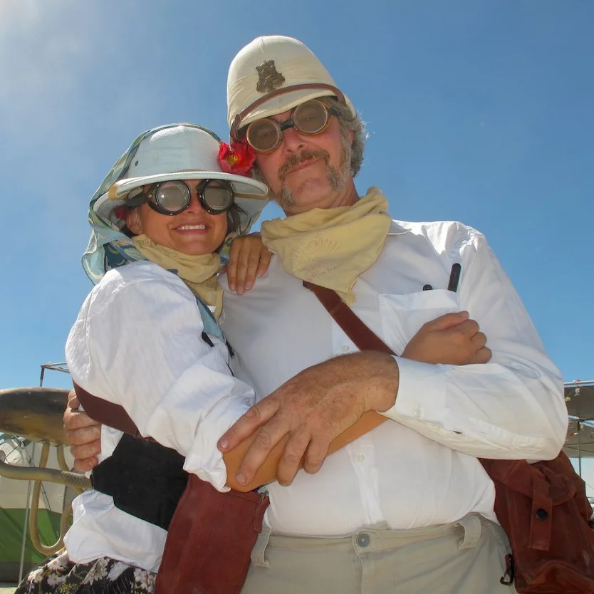 Kimric Smythe and Autumn Kruse are like two poles of a magnet. Kimric was the chief engineer of the Neverwas Haul, the Steam Car, and is a legendary Burning Man/Survival Research Labs prankster/artist/engineer and pyrotechnician. Autumn runs the numbers and speaks Russian. Both love the obscure and the odd. Kimric owns an accordion repair shop and Autumn has her own accounting business.