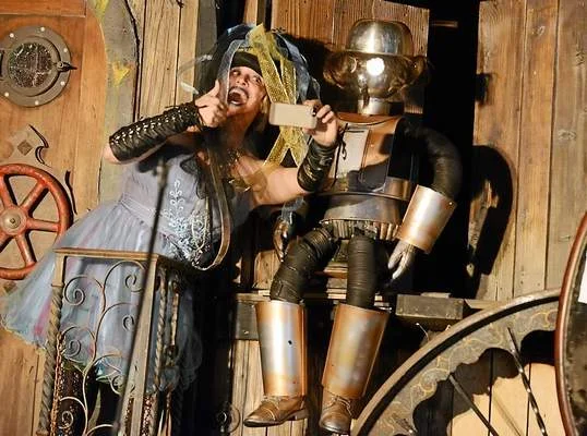 The Blue Fairie played by Susan George takes a selfie with Steampunk Pinocchio as she turns him into a real boy during the Feast of the Tentacle 4th Anniversary of Obtainium Works in Vallejo on Saturday.