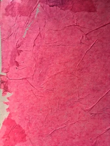 Regular pink tissue paper applied with gel medium.