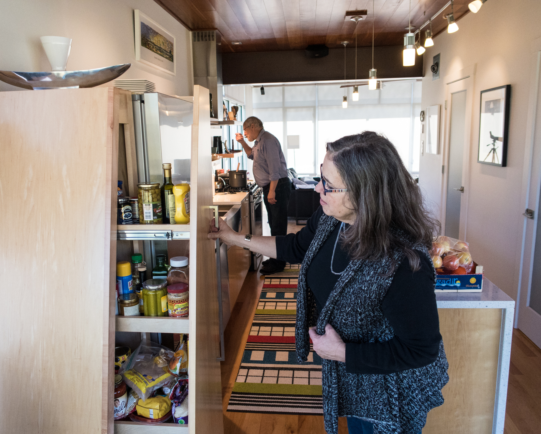 Denise shows us her custom cabinets as Michael tastes the etouffe. "C'est Bon!" he says...