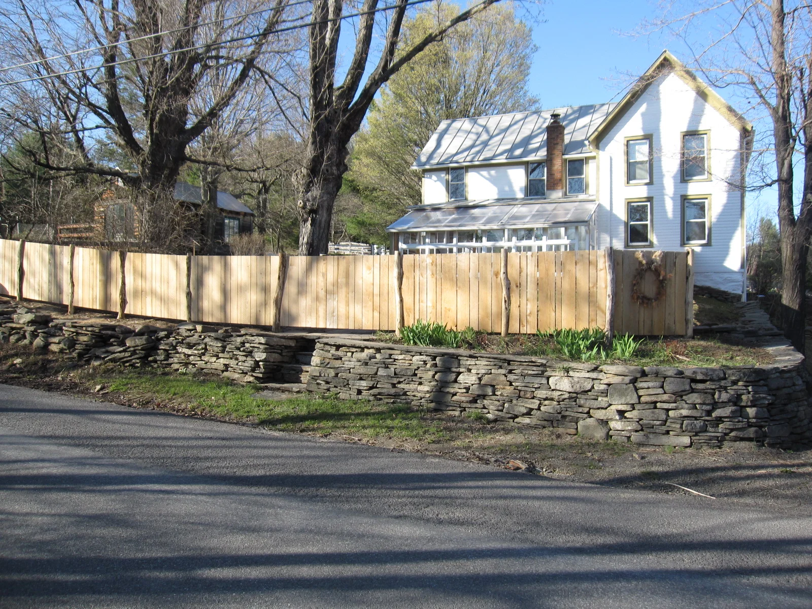  Balancing the&nbsp;regular formality of the planes of milled lumber and the curvatures of the untamed locust posts allows this fence to&nbsp;compliment&nbsp;an old farmhouse with a modernist sensibility. 