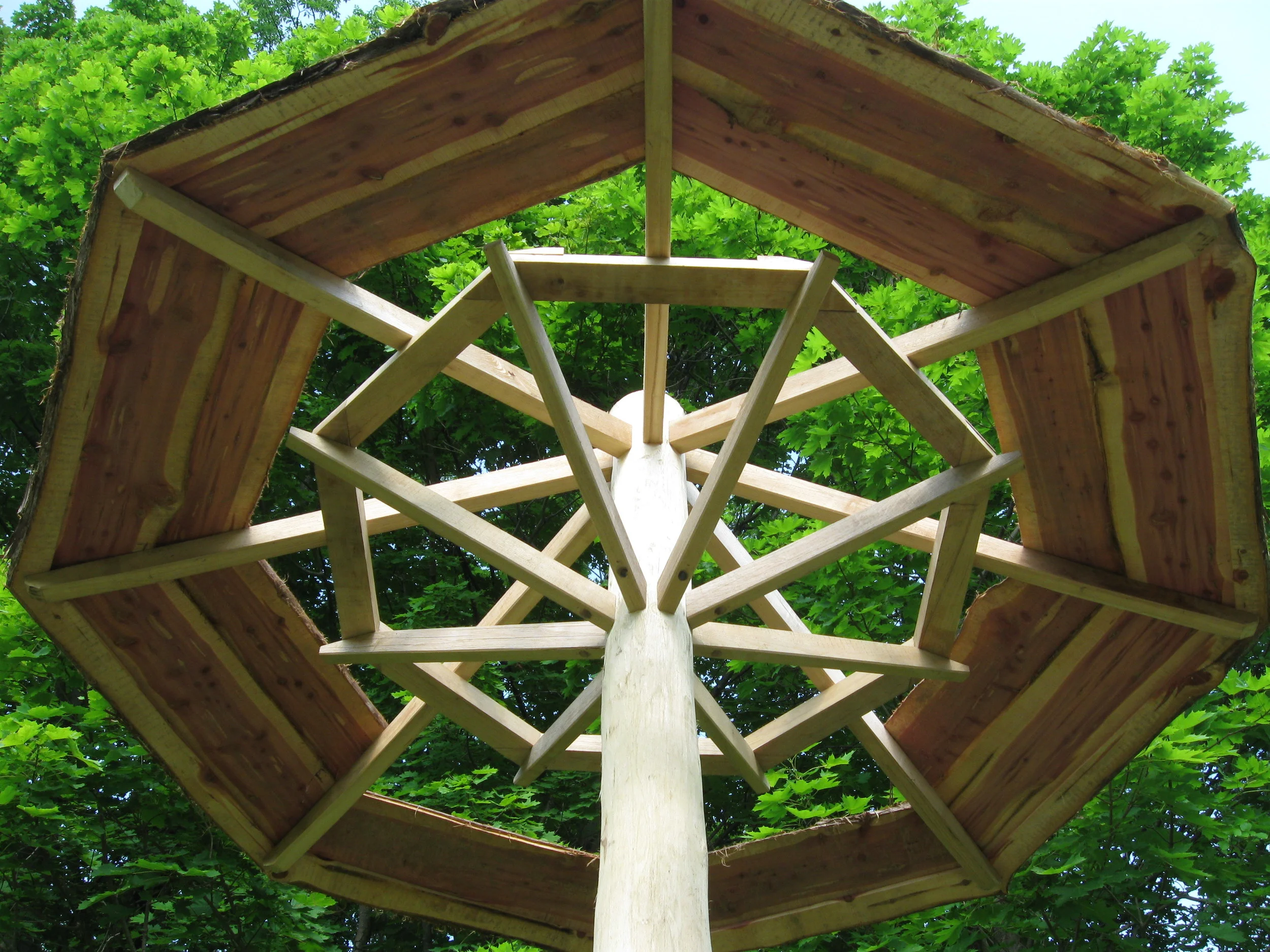  We brought the braces above head height and broke their direct connection to the rafters with introduction of a&nbsp;purlin ring. Allowing a structure that has to be strong enough the weather the winter winds off the river, the visual impression tha