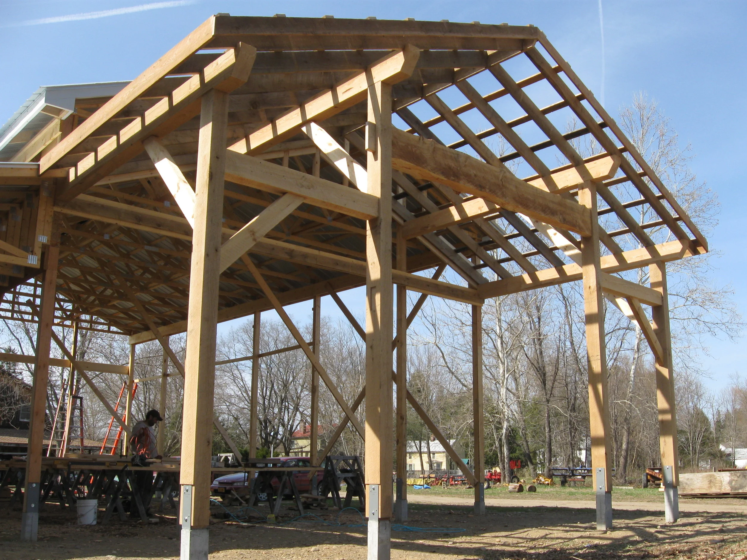  A timbered addition to a pole barn at Hearty Roots farm, the porch provides a rustic space&nbsp;to the public and covered work area to the crew. 
