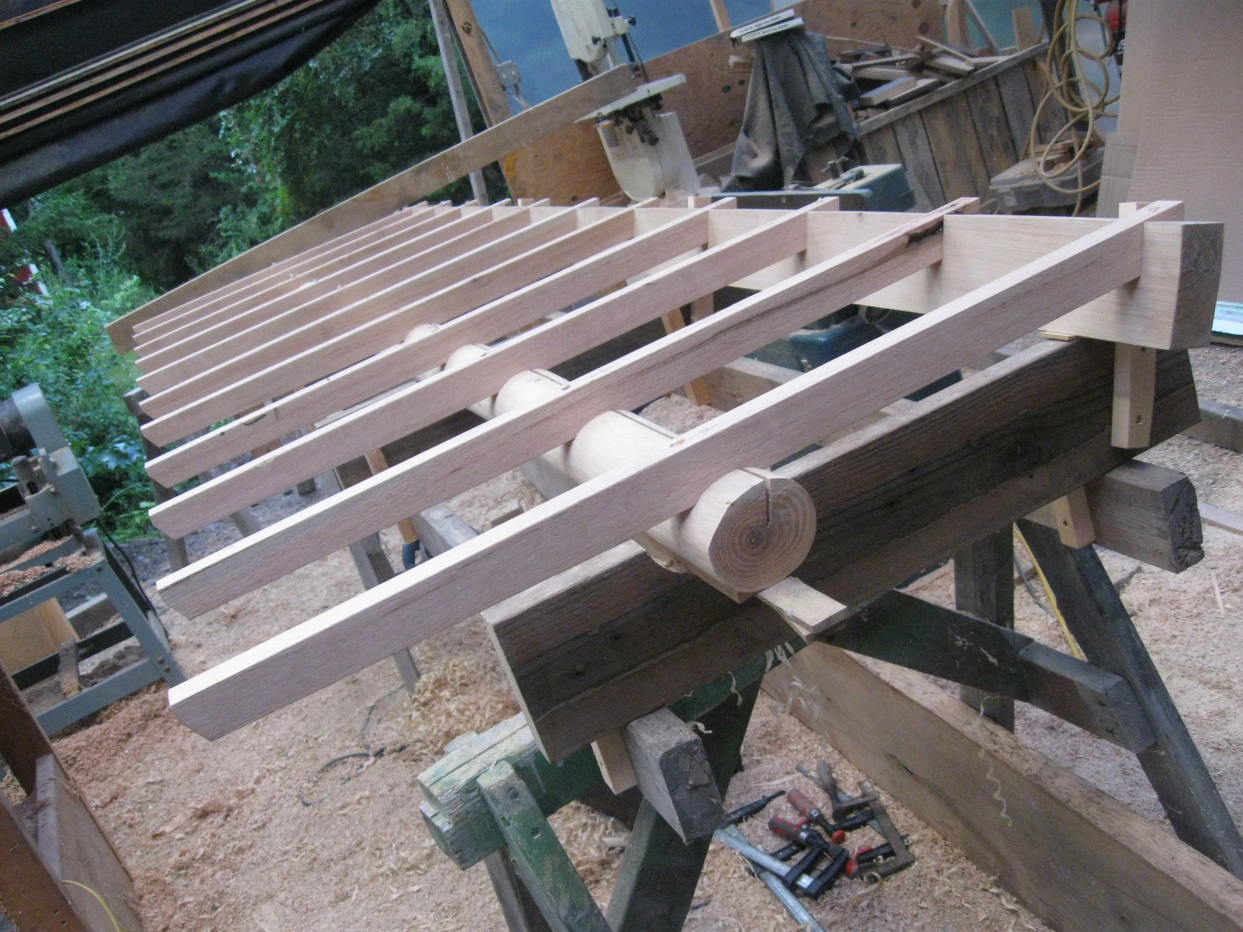  Roof plane of the overhang being notched&nbsp;into the natural curves of the beam, which makes use of the old technique of&nbsp;a kerf down the top to control checking. 