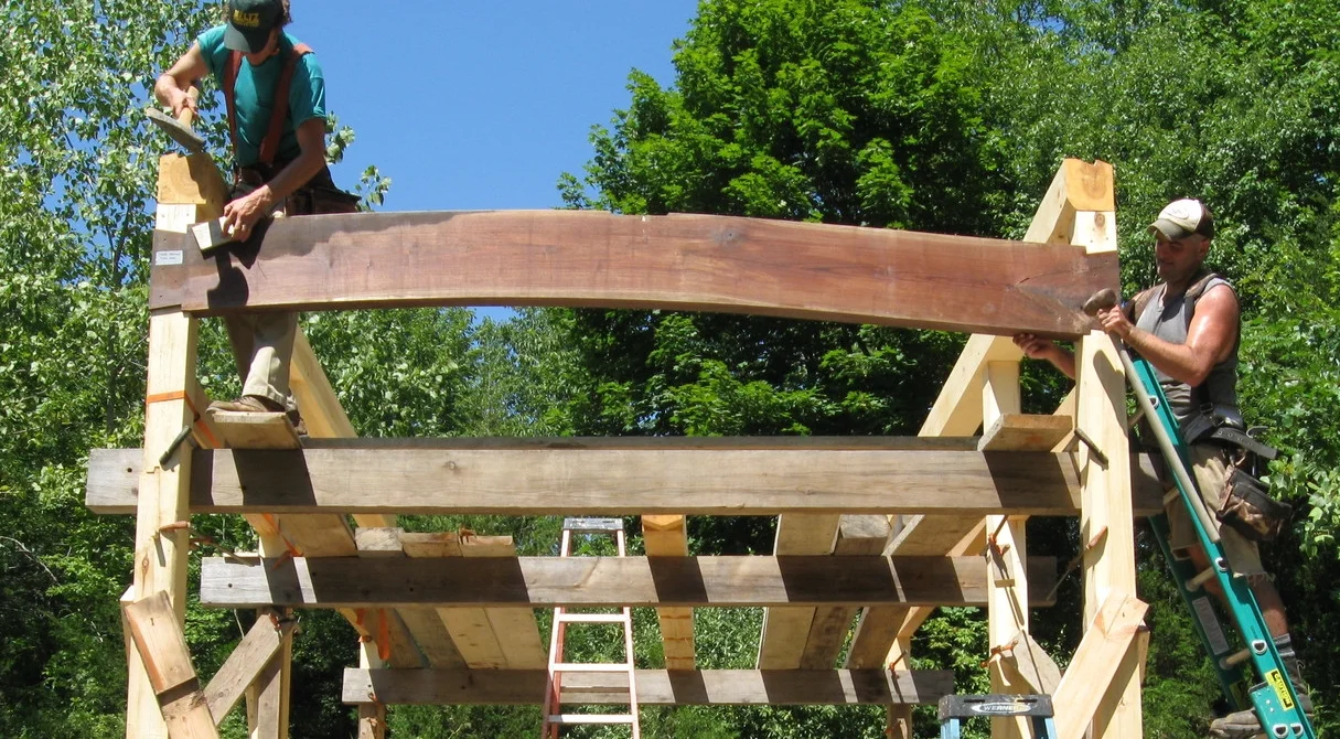  Driving home the bookmatched walnut tiebeams. 