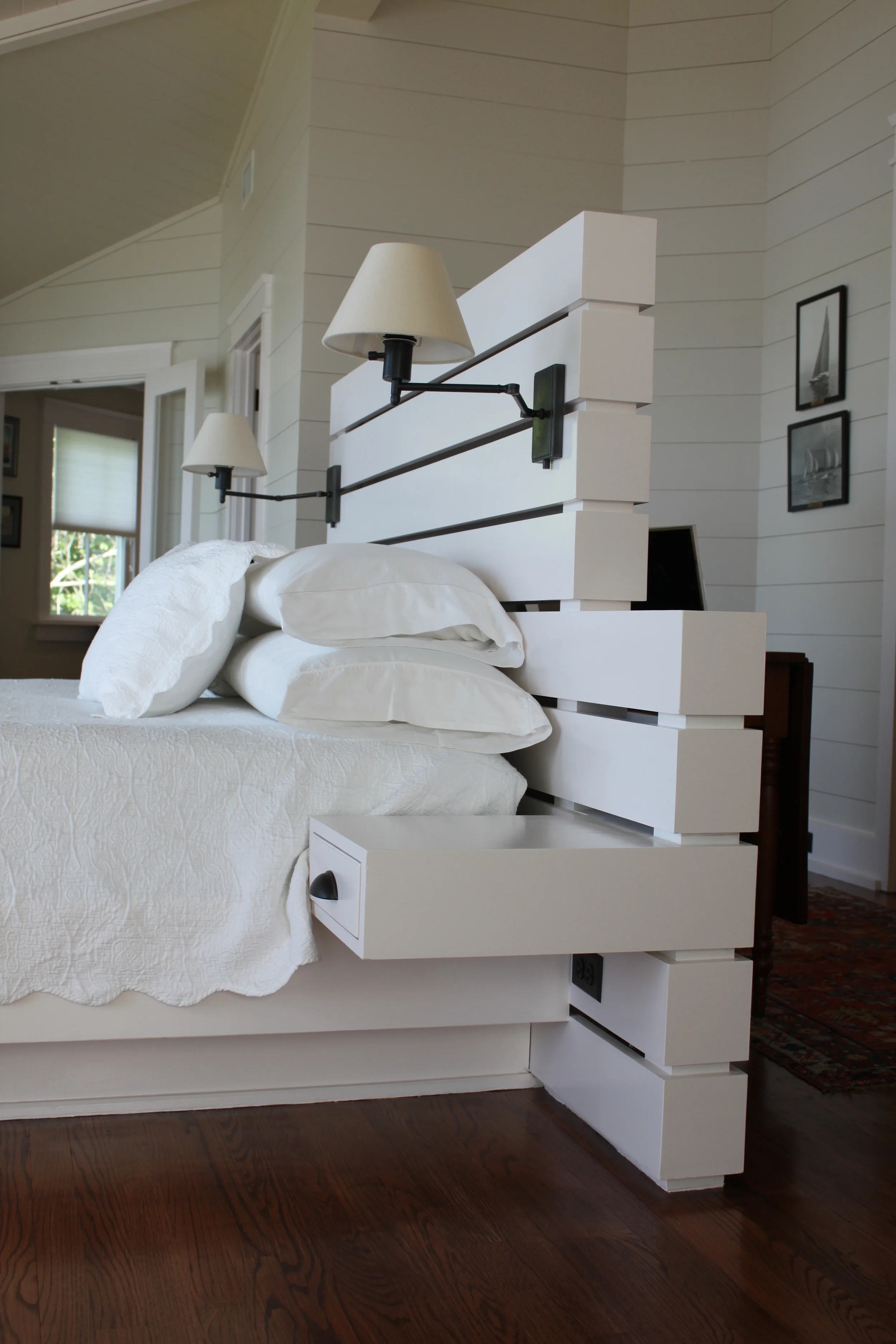  Designed to float within a renovated master bedroom space of a Sullivan's Island home, this bed integrates end table function and lighting. 