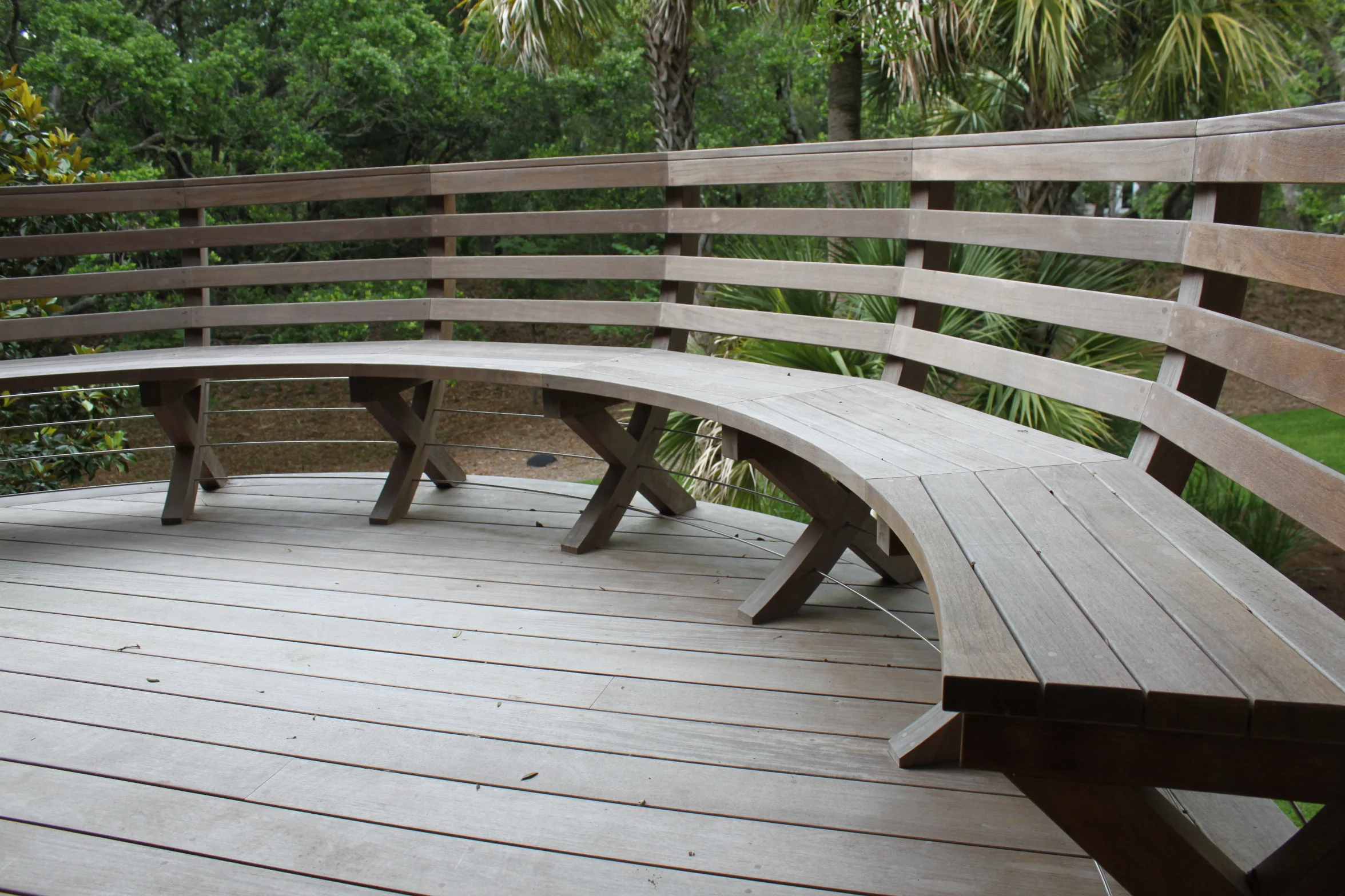  These Ipe benches serve the dual purpose of providing safety and seating capacity to the perimeter of two elevated decks. This design also solves the problem of turning the existing radiused deck edges otherwise protected with new cable rail systems