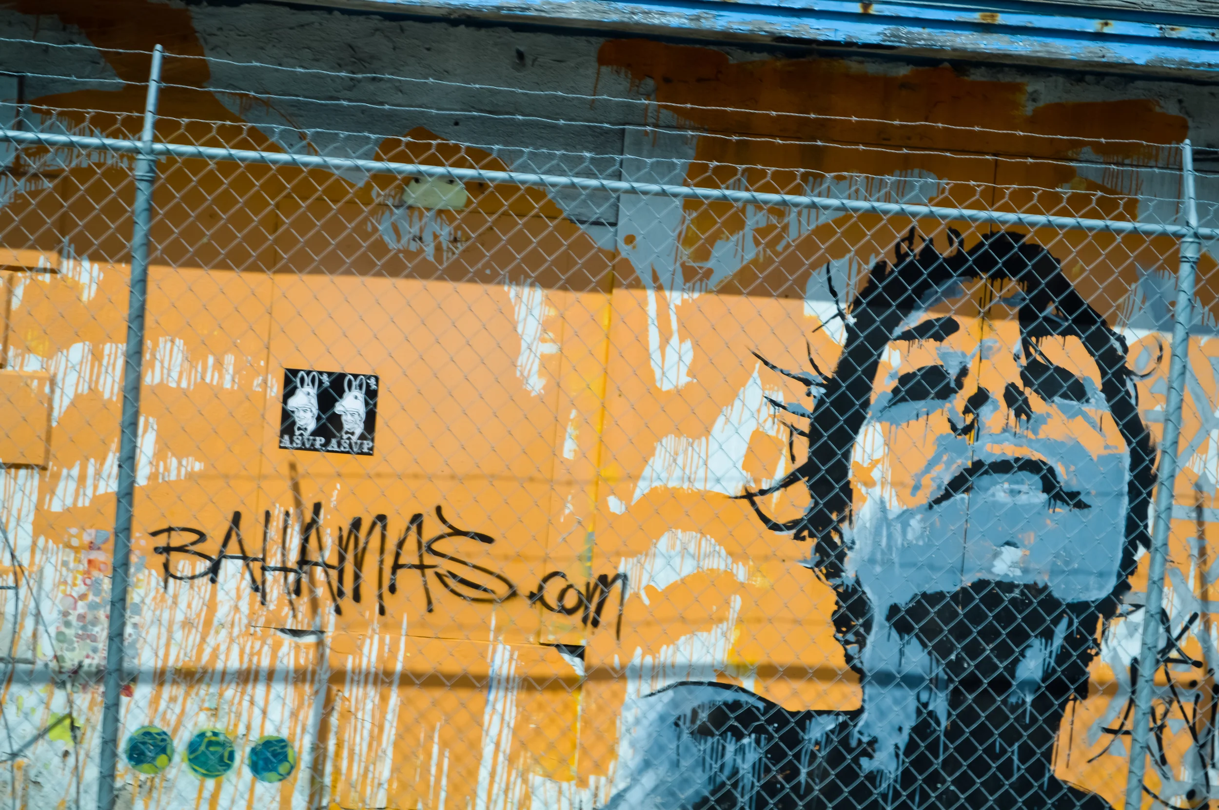 Graffiti of woman behind a barbed wire fence