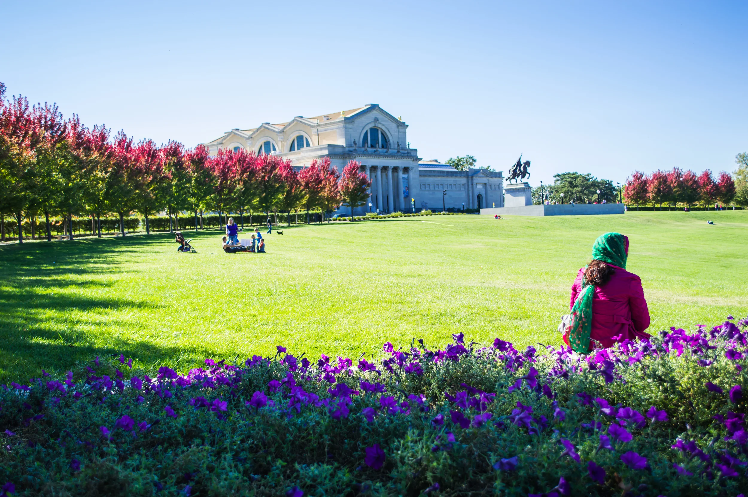 Woman in traditional ethnic dress, sitting in park