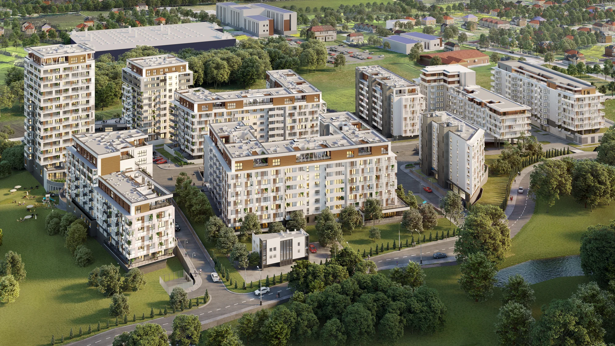 Widok z lotu ptaka na nowoczesny kompleks mieszkaniowy z kilkoma białymi i brązowymi budynkami wielopiętrowymi, otoczony zielonymi trawnikami, drzewami oraz parkiem z małym stawem.