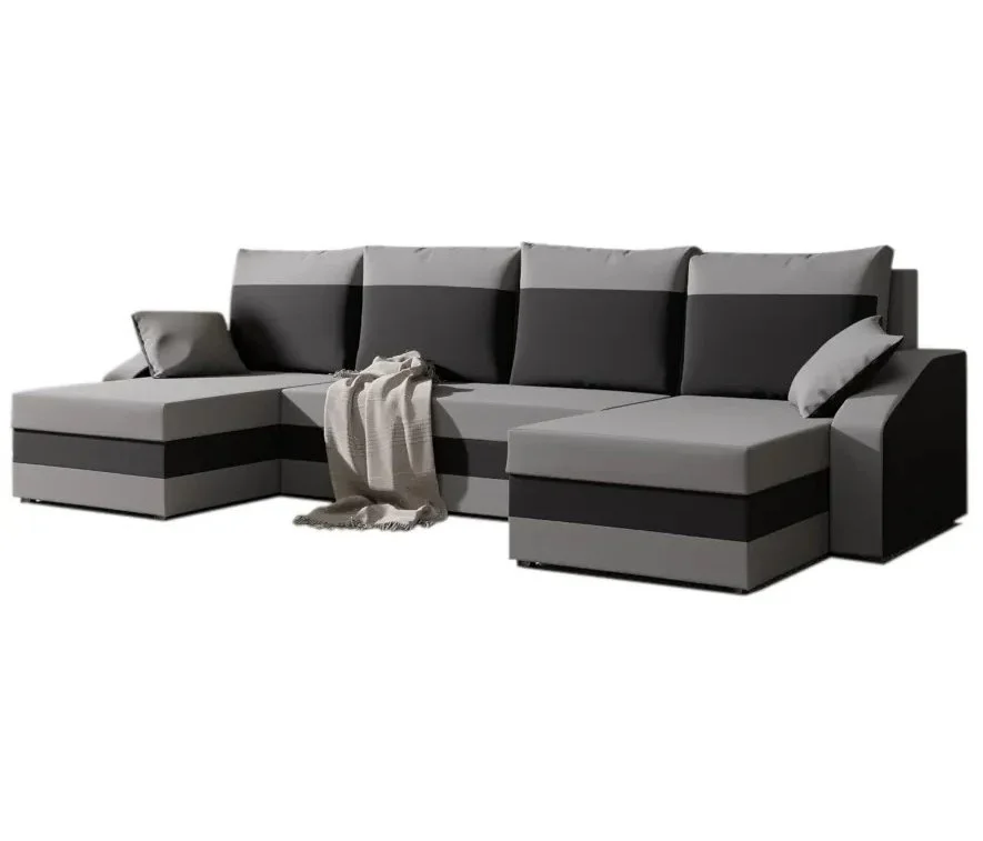 Szaro-czarna sofa narożna z poduszkami i kocem, na białym tle.