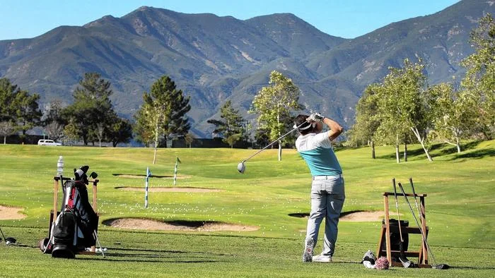 Brent Meschuk practices his swing at the driving range overlooking Saddleback Mountain at the Dove Canyon Golf Club.