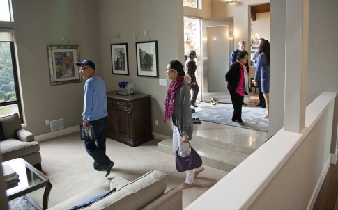 Chinese cash-bearing homebuyers tour a house in California.