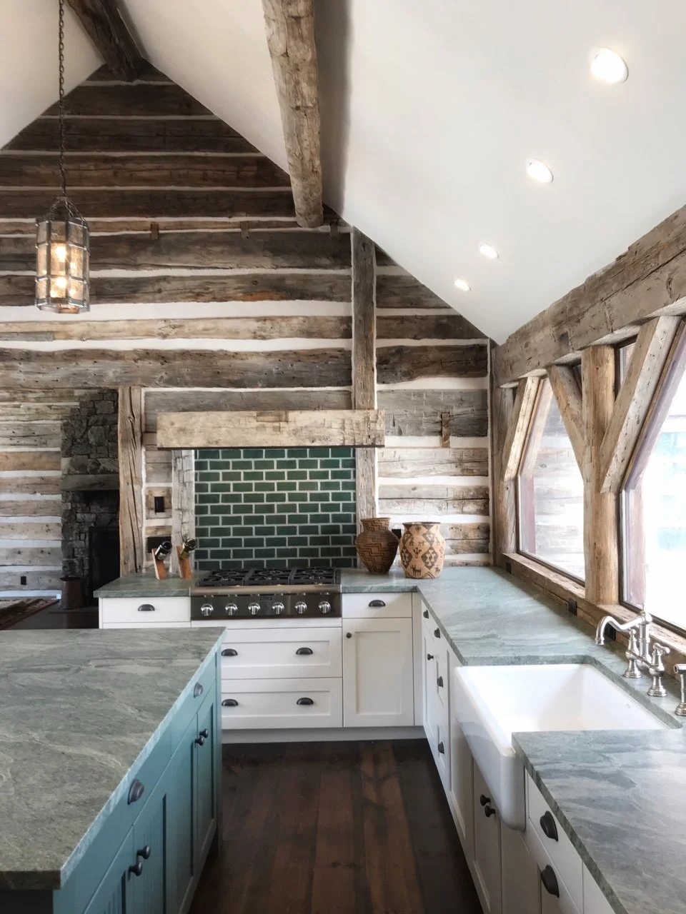 The full kitchen complete with rustic timbers and green granite countertops.