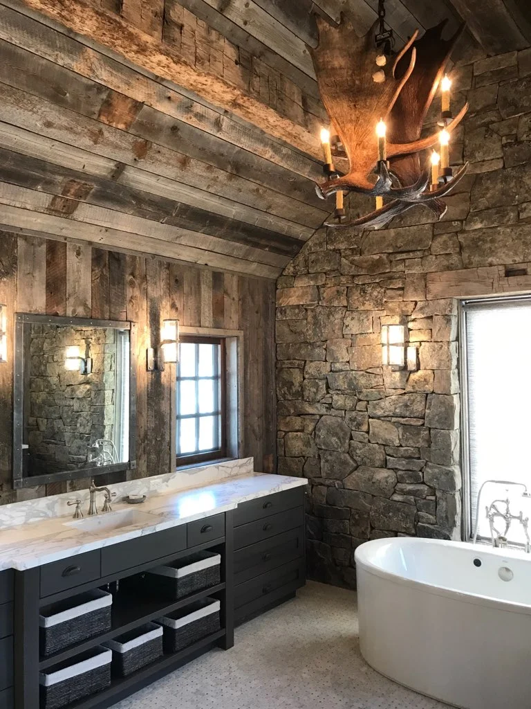 Master Bathroom with rustic timbers, granite stone walls and antler chandelier.