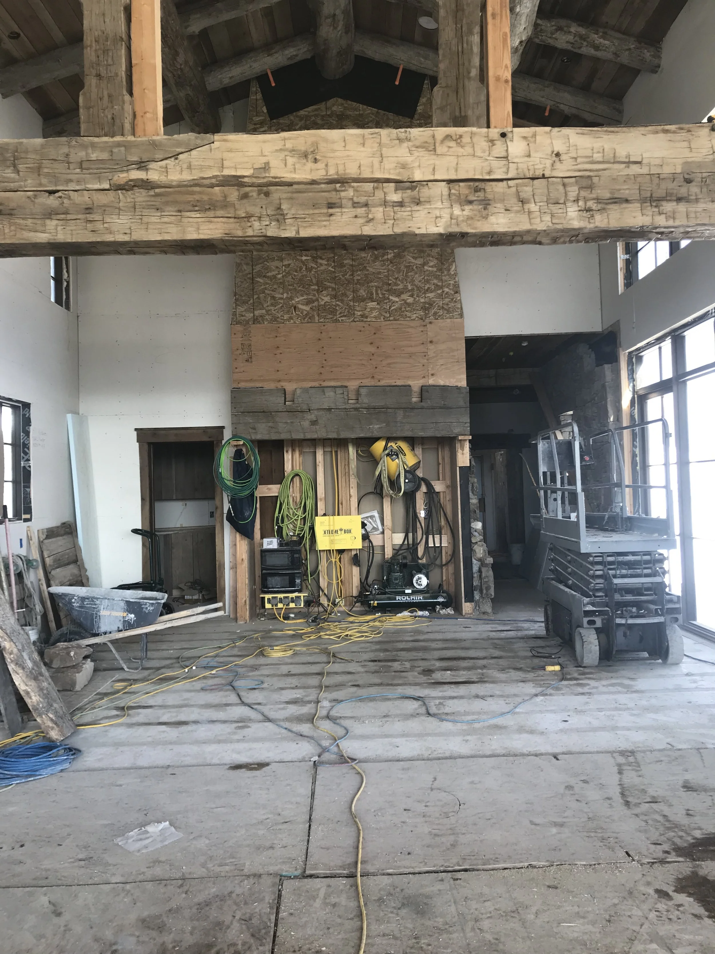 Yellowstone Club Montana Custom Home Design Central Living Area Reclaimed Wood Beams and Custom Fireplace.jpg