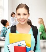20772279-happy-student-girl-with-school-bag-and-notebooks-at-school.jpg