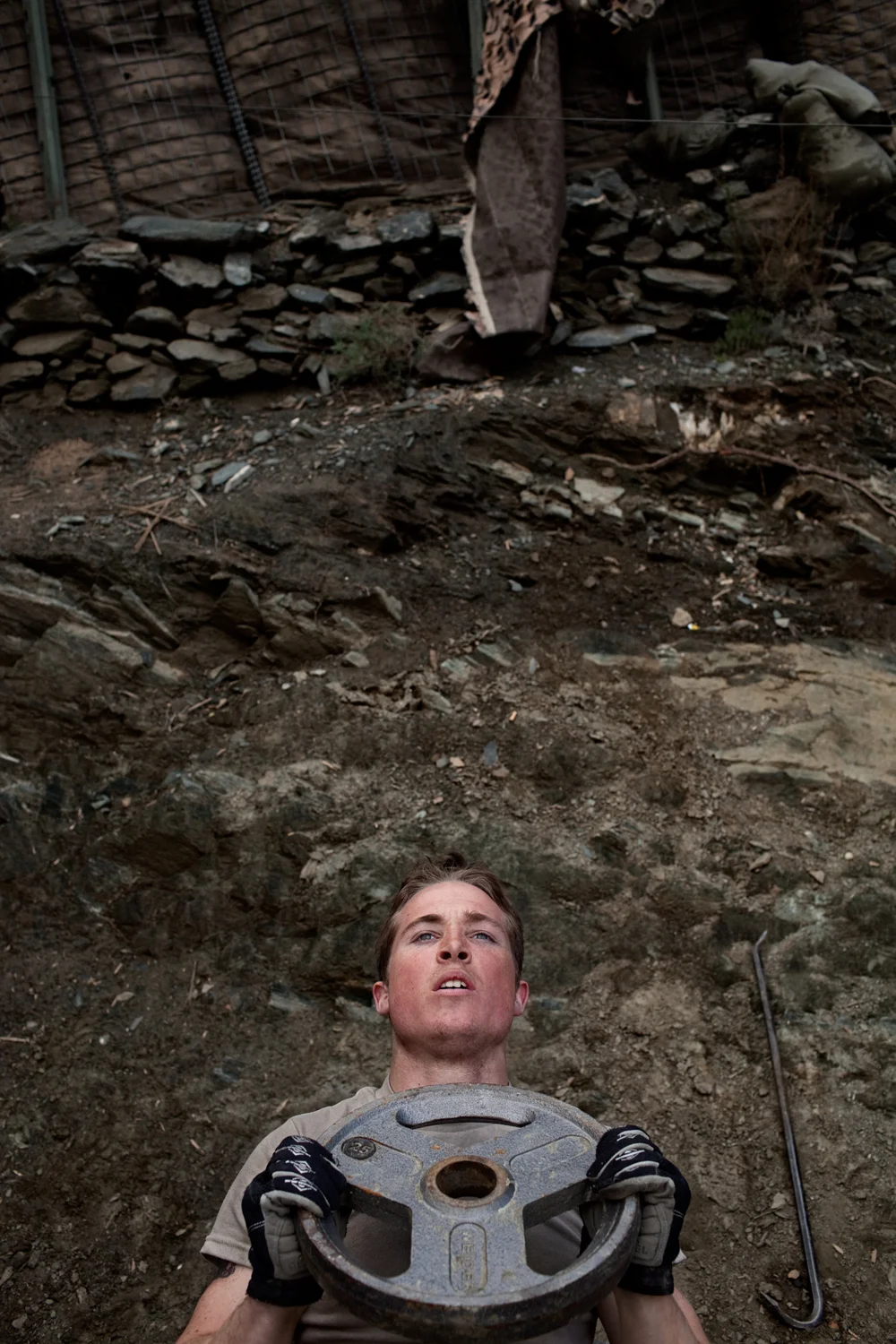 A U.S. Army soldier works out at Observation Post Dallas in the Korengal Valley, Kunar Province, Afghanistan.