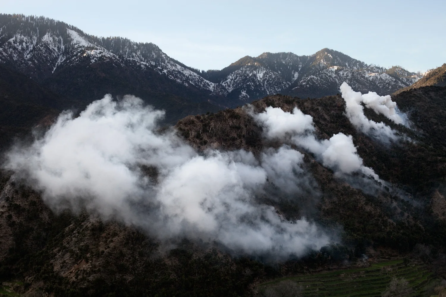 Smoke clouds from white phosphorous mortars fired by U.S. Army in the Korengal Valley, Kunar Province, Afghanistan.