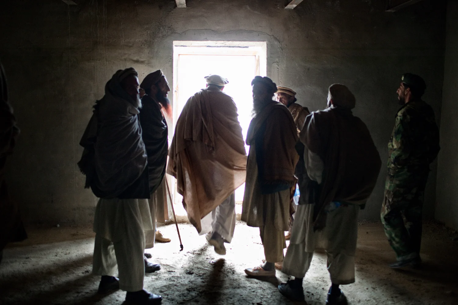 Village elders leave a meeting with U.S. Army soldiers after seeking compensation for battle damage and the release of a detained local, at the Korengal Outpost, Kunar Province, Afghanistan.
