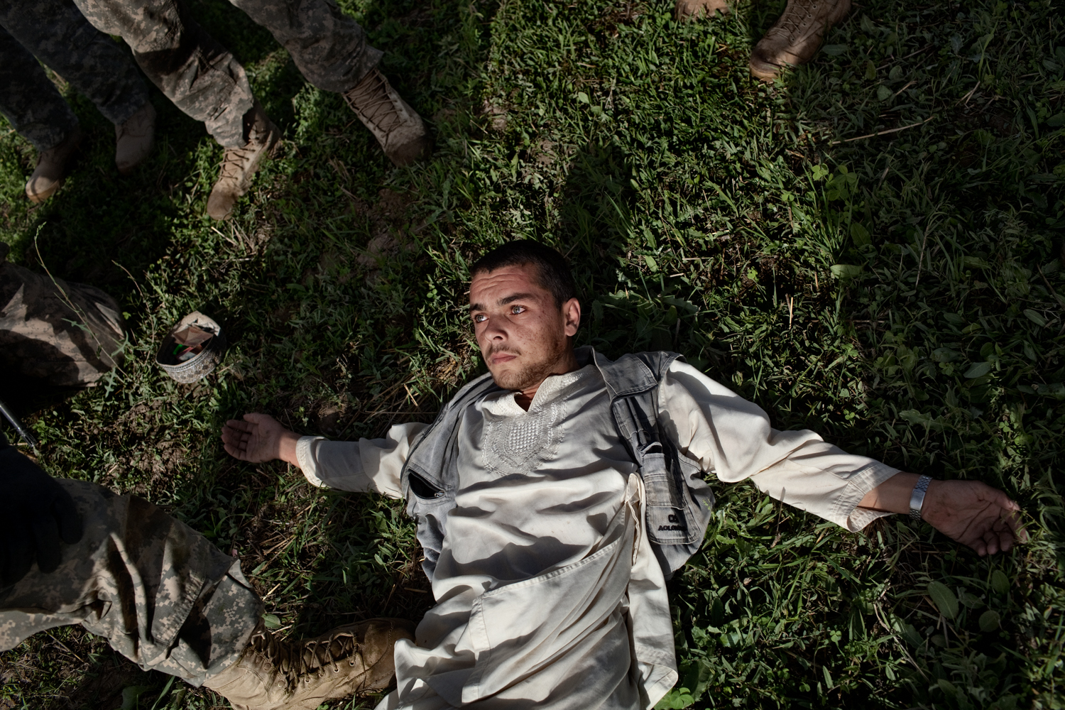  An Afghan man is searched by U.S. Army in the Tangi Valley, Wardak Province, Afghanistan.    