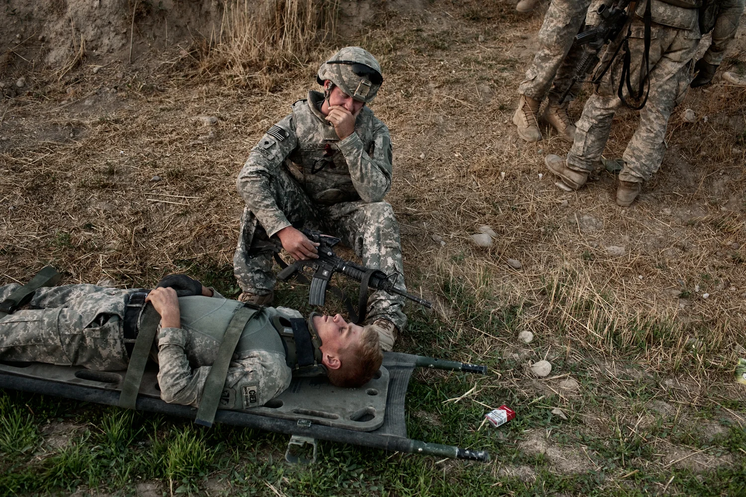 U.S. Army Specialist T.J. Fecteau lies on a stretcher after being concussed in an improvised explosive device attack on his vehicle in the Tangi Valley, Wardak Province, Afghanistan.