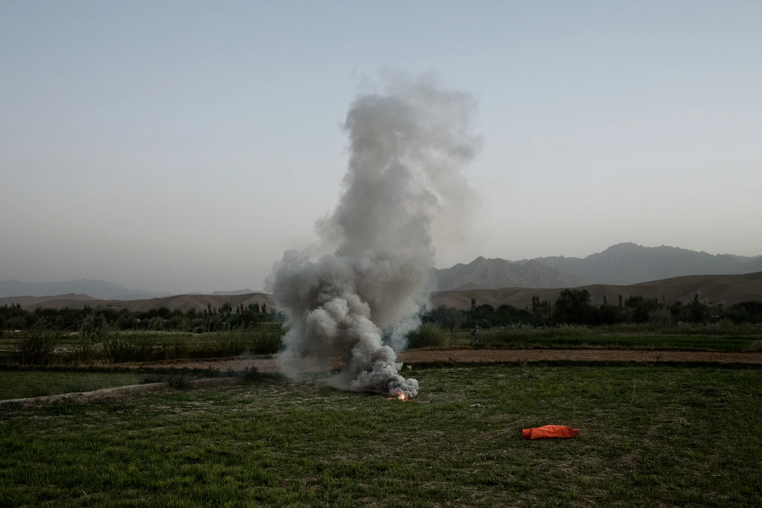 A flare marks a landing zone for medical evacuation helicopters after three U.S. Army Soldiers were injured in an improvised explosive device attack in the Tangi Valley, Wardak Province, Afghanistan.