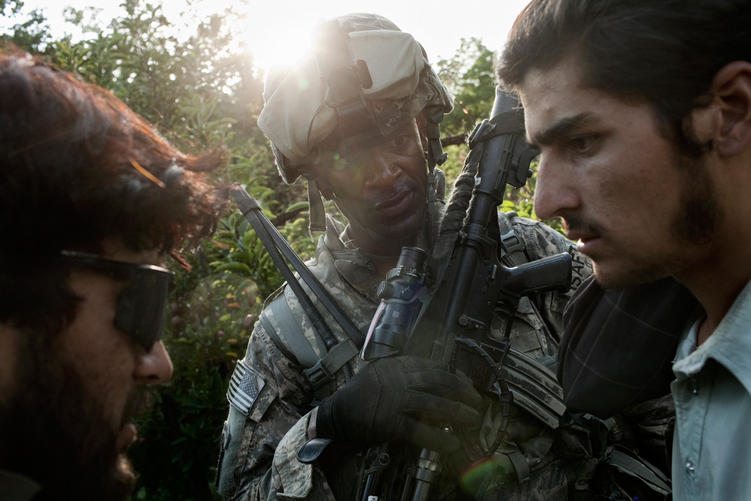 A U.S. Army soldier and Afghan interpreter question a local villager in the Tangi Valley, Wardak Province, Afghanistan.