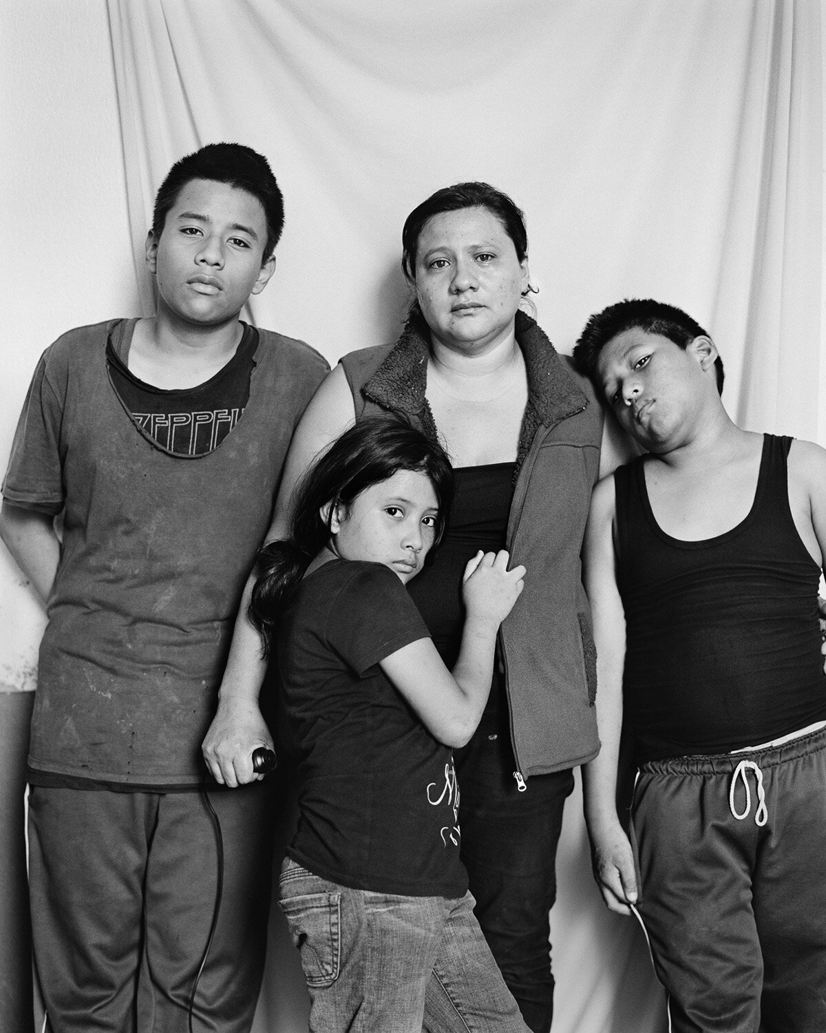  América Yanira López, 35, and her children, Miguel, 12, Philipe, 10, and Adriana, 7, from El Salvador, at a Catholic shelter in Reynosa, Mexico. Photograph by América Yanira López and Adam Ferguson 