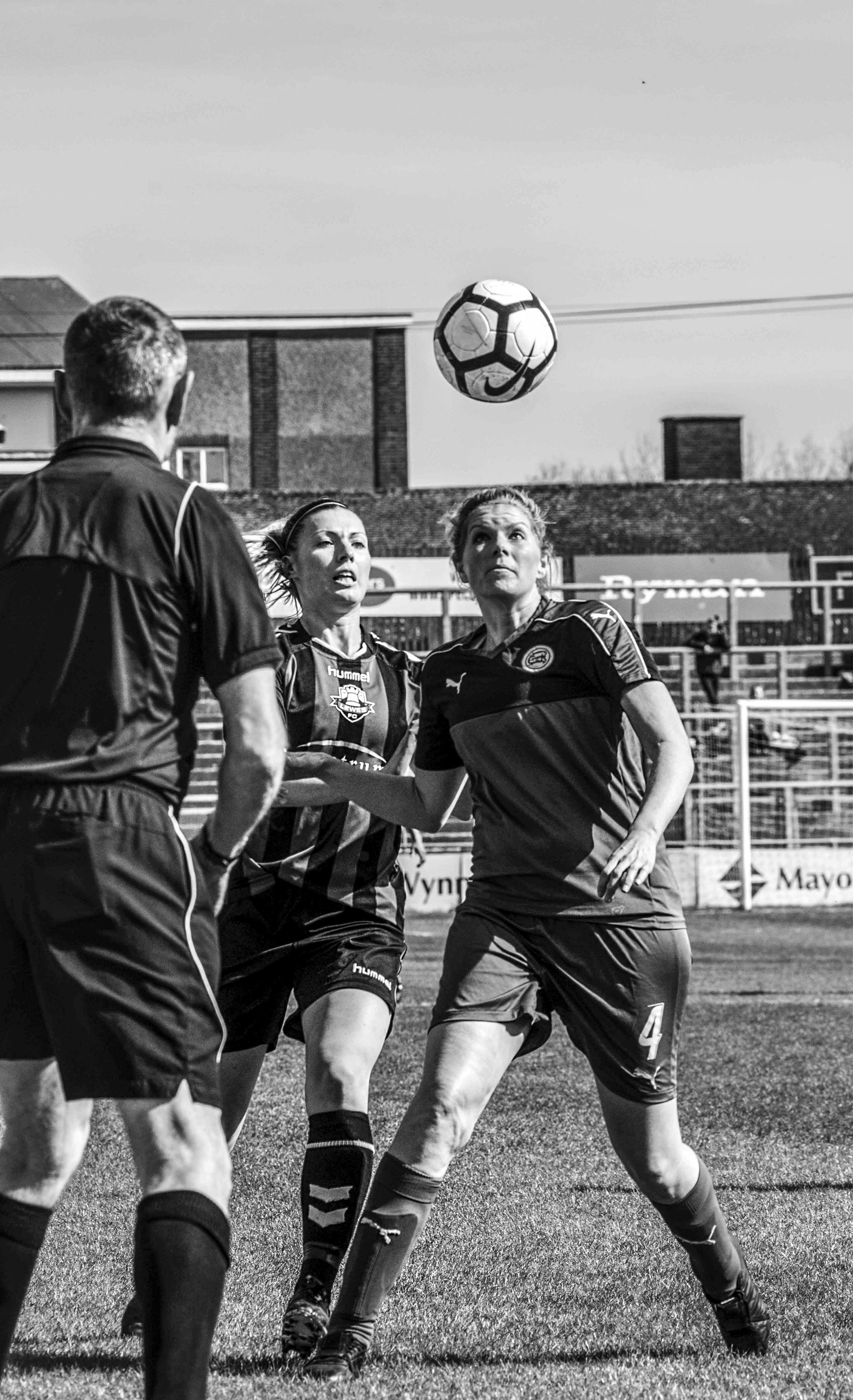 Women footballers going for the ball.jpg