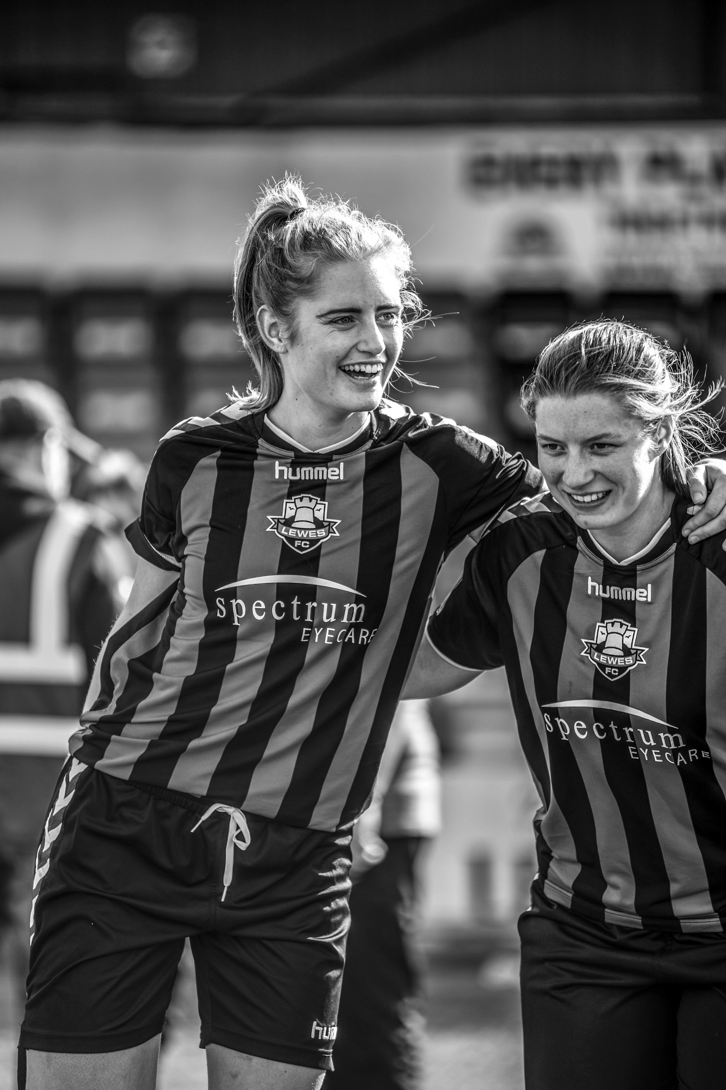 Two women footballers smiling.jpg