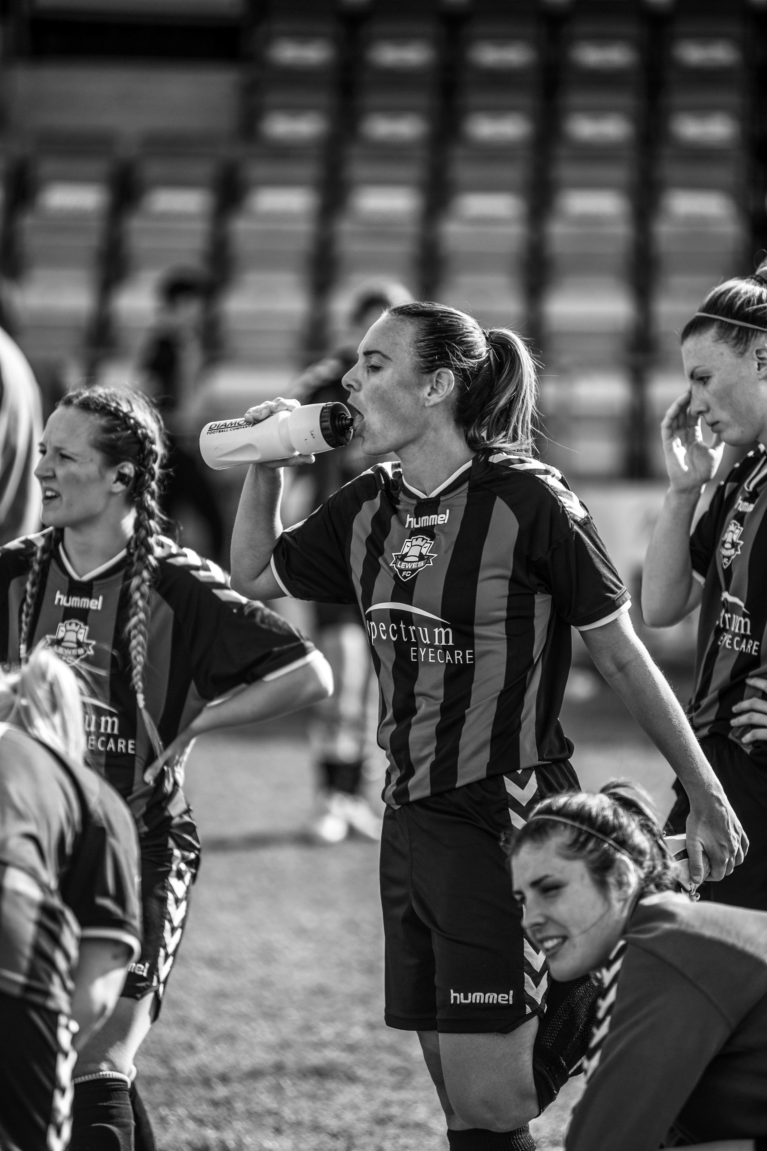 Woman footballer drinking from bottle.jpg