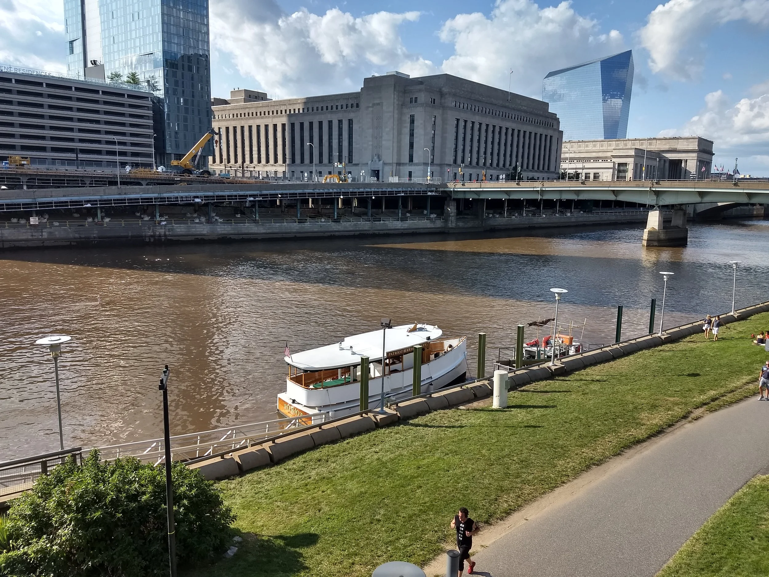 Boat docking with historic 30th Street transit station, which opened in 1933, in the background
