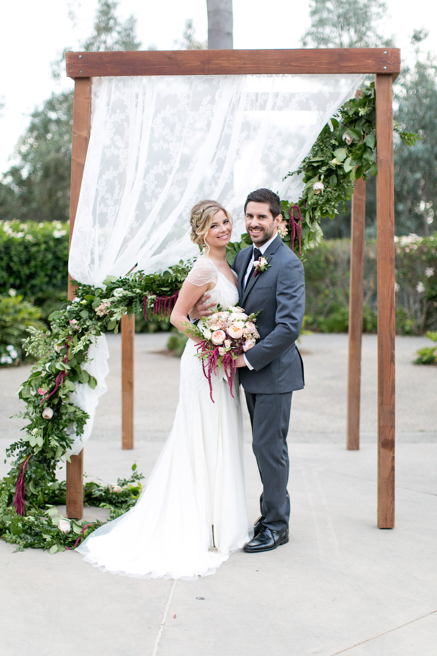 Wedding ceremony garland on chuppah by San Diego florist, Compass Floral.