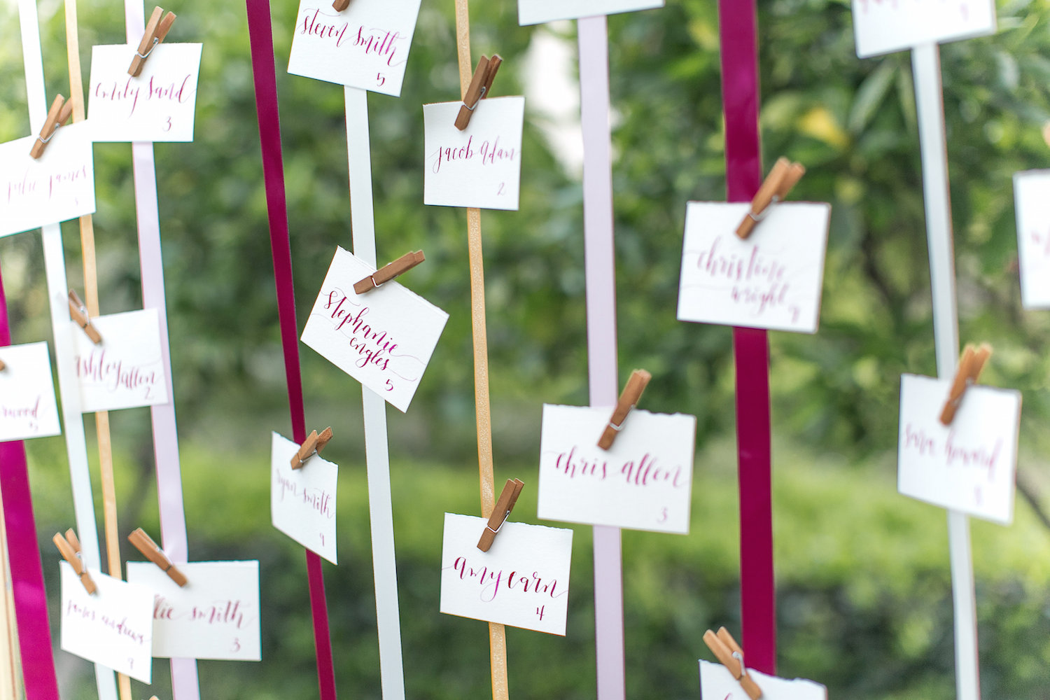 Ribbon wedding escort card display by San Diego Florist, Compass Floral.