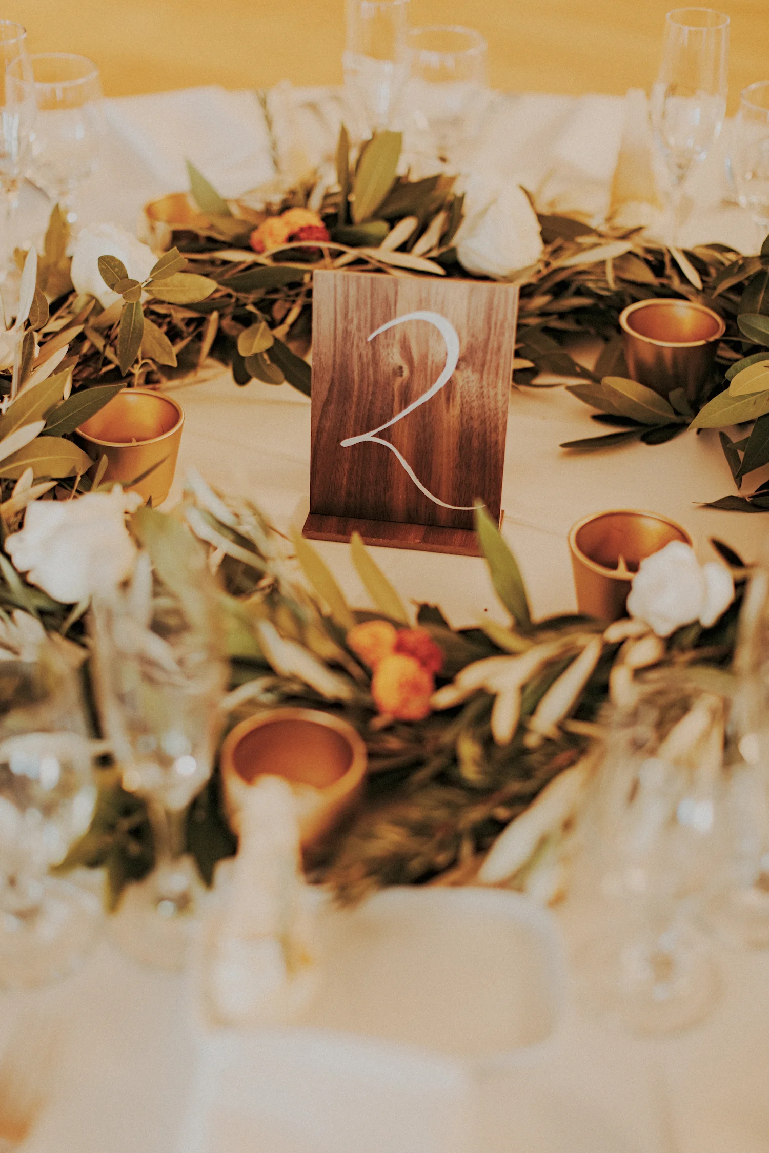 La Jolla Womans Club rosemary & bay leaf garland centerpiece by San Diego wedding florist, Compass Floral.