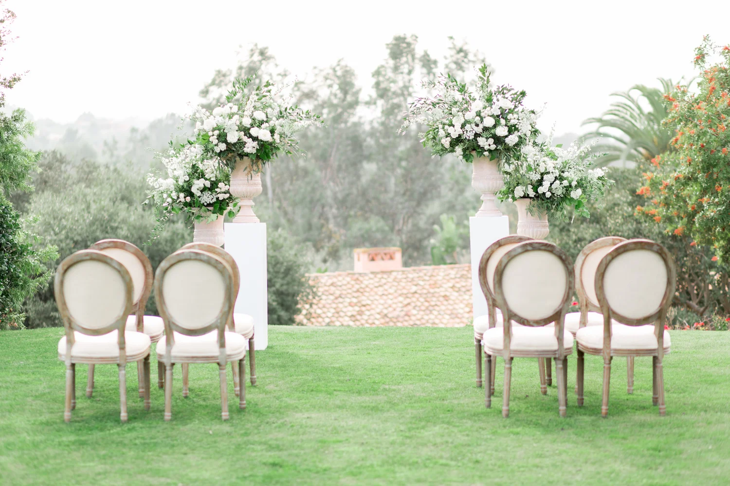 Elegant white pedestal wedding ceremony | Rancho Valencia Weddings | Rancho Santa Fe | Compass Floral | Wedding Florist in San Diego and Southern California | Cavin Elizabeth Photography