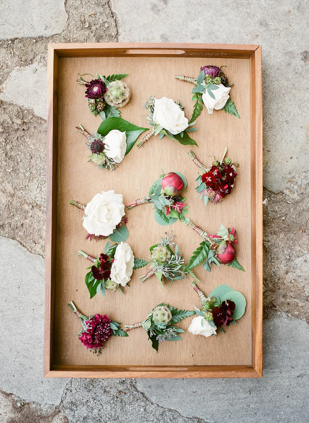 Mismatched burgundy and white boutonnieres by Compass Floral | Fallbrook Treehouse, Fallbrook