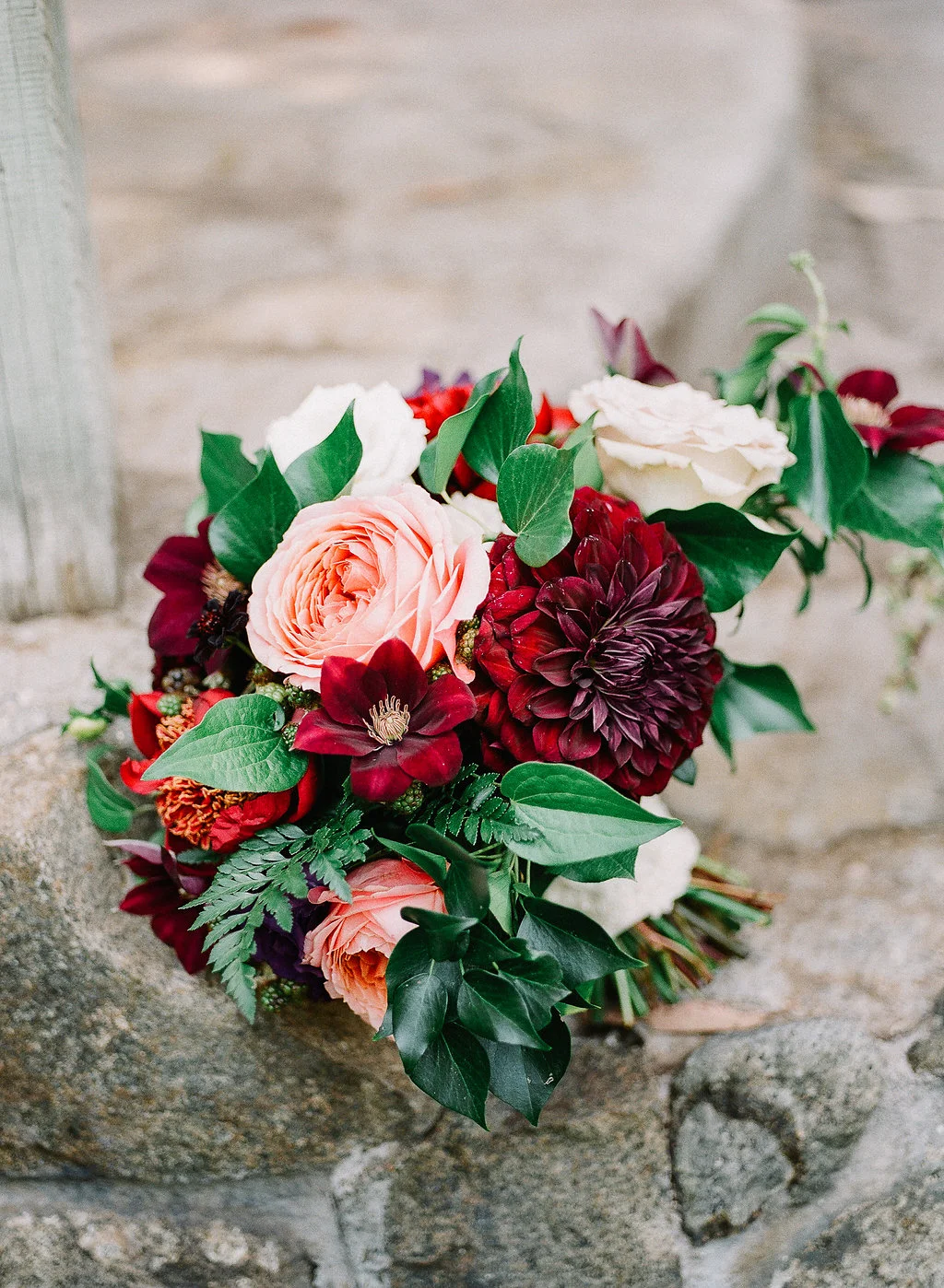 Romantic, jewel tone bridal bouquet of romantic antike garden roses, dahlias and clematis by Compass Floral | Fallbrook Treehouse, Fallbrook