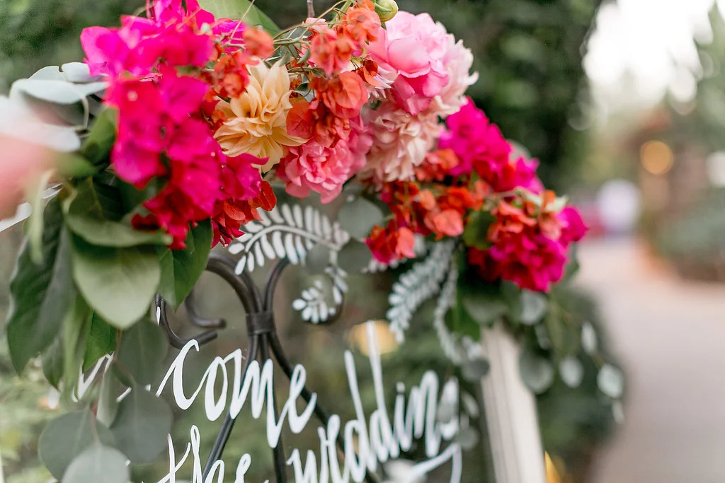 Bohemian wedding welcome sign with floral garland by Compass Floral | Estancia Hotel & Spa, La Jolla.