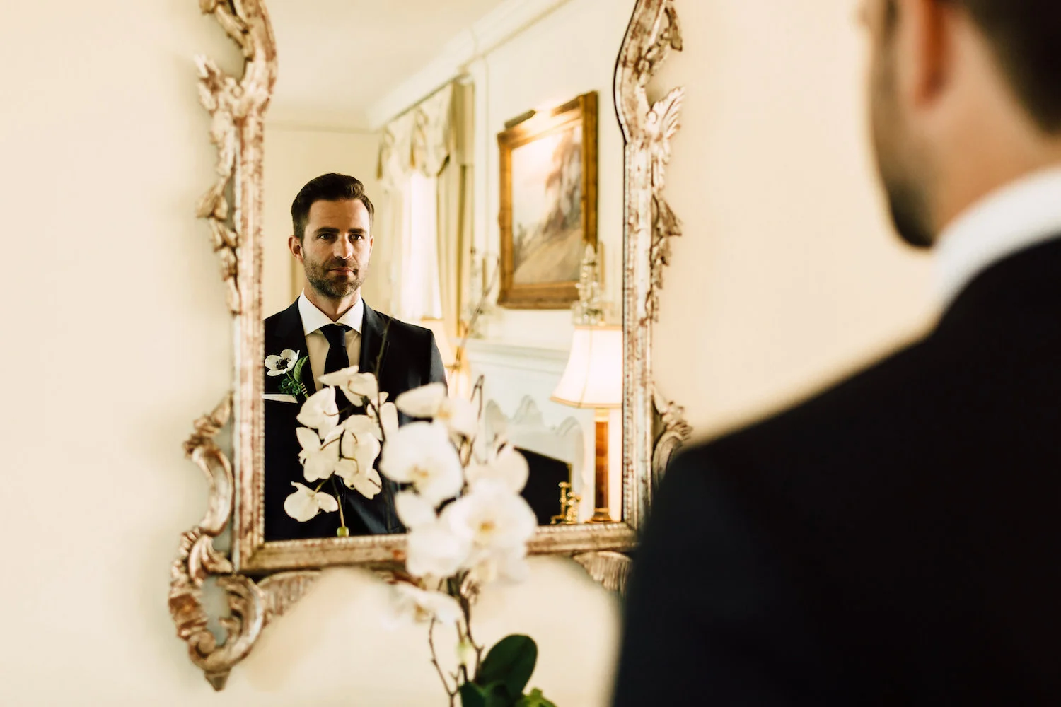 Elegant groom with anemone boutonniere by Compass Floral | Darlington House, La Jolla.