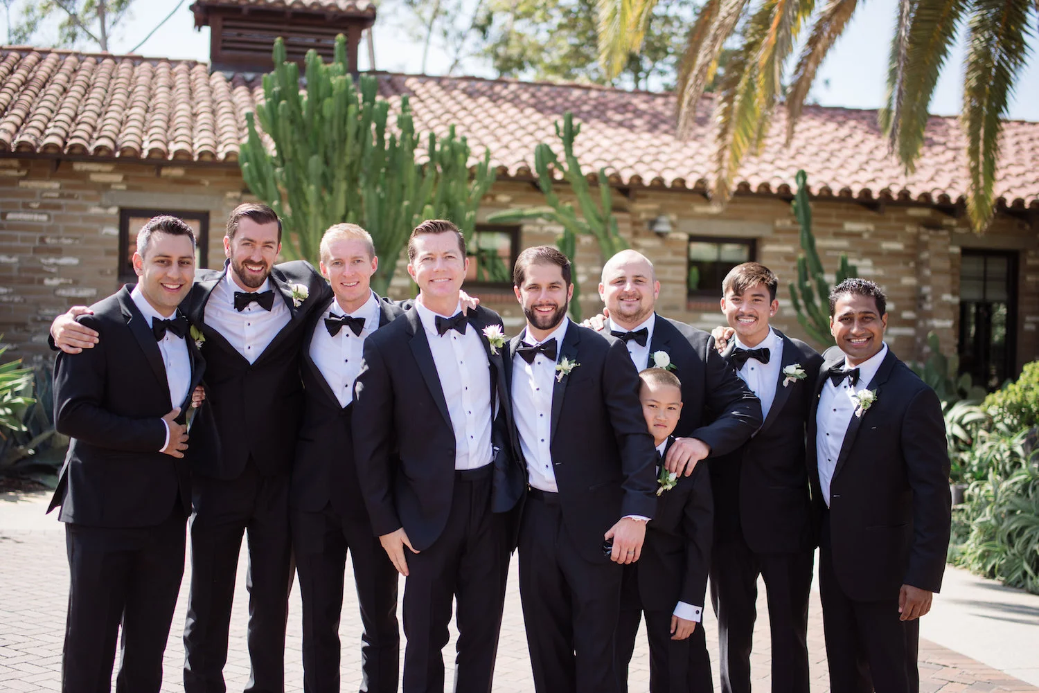 Black bow-tie groomsmen, boutonnieres by Compass Floral | Estancia Hotel & Spa, La Jolla