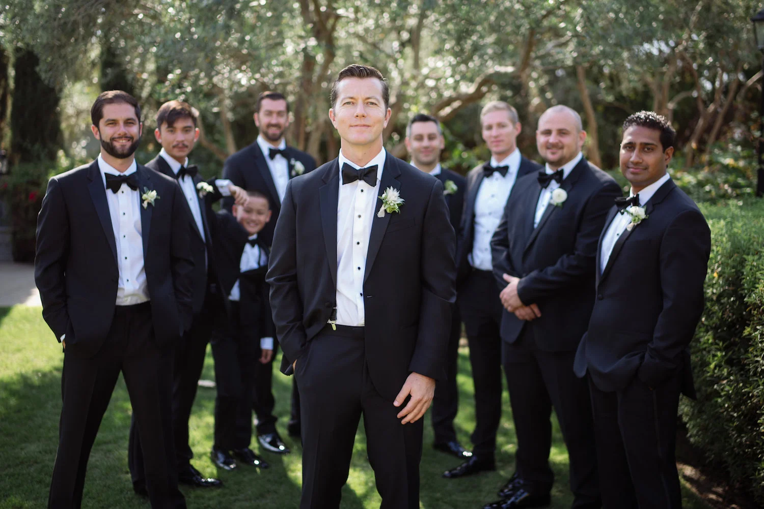 Black bow-tie groomsmen, boutonnieres by Compass Floral | Estancia Hotel & Spa, La Jolla
