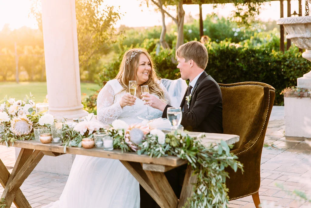 Bohemian wedding garland sweetheart table with lanterns | Mount Palomar Winery Weddings | Compass Floral Design | Wedding Florist in San Diego and Southern California | Ashley Paige Photography